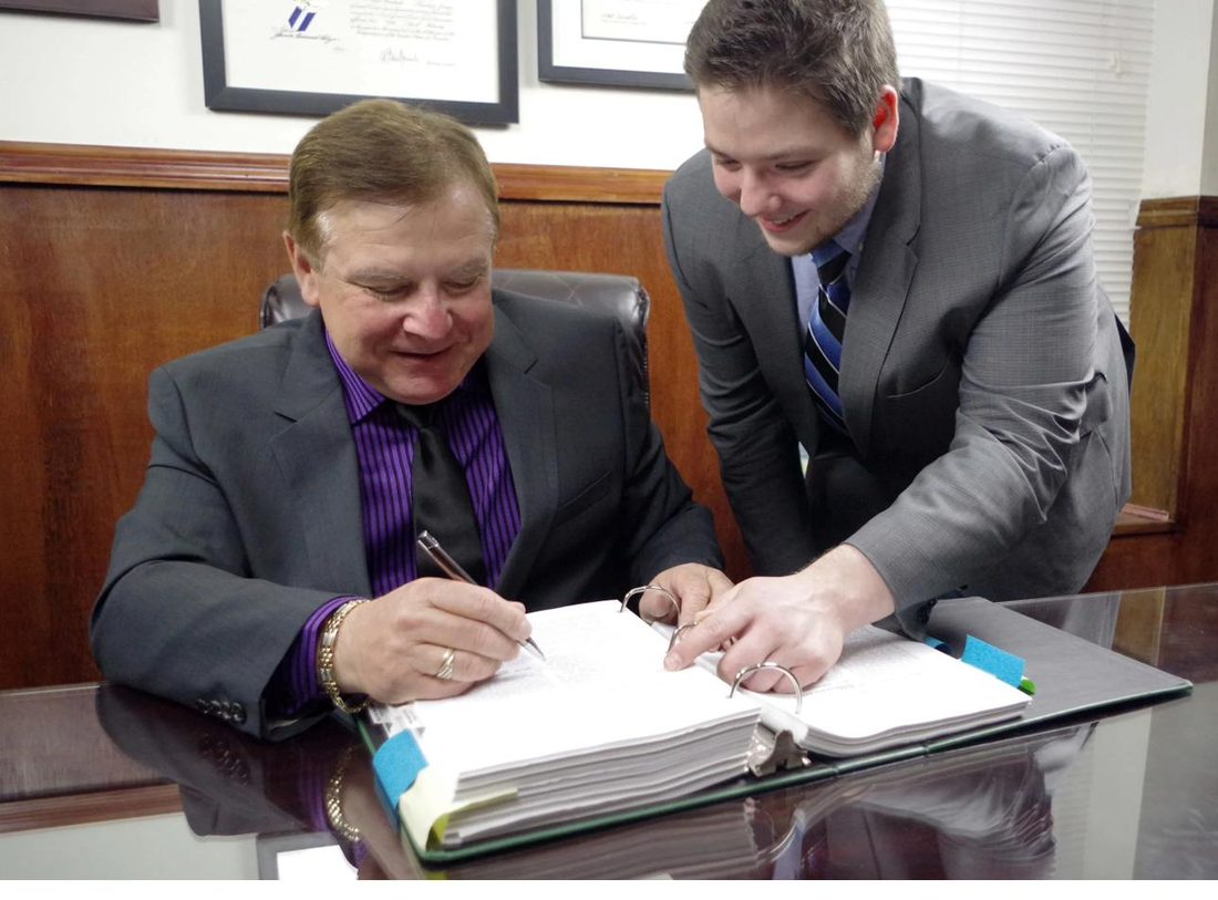 Greg and Michael Gorodetsky reviewing a case file together